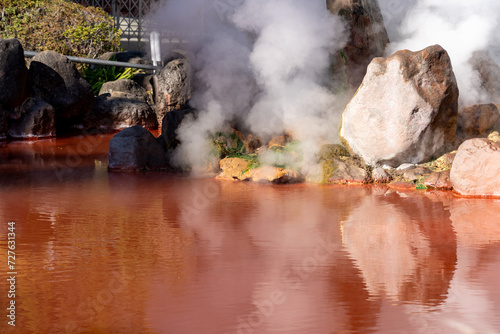A pond of boiling, red water at Umi Jigoku in Beppu, Japan photo