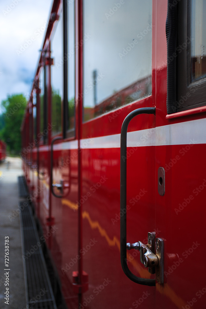 Close up: cabin doors of a vintage red train parked on tracks,Austria
