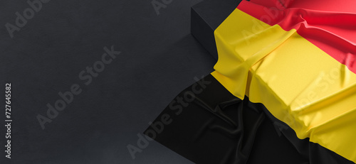 Flag of Belgium. Fabric textured Belgium flag isolated on dark background. 3D illustration