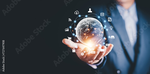 Businessman holding virtual world with icons and connection line for data exchange from globalization innovation technology and global business concept.