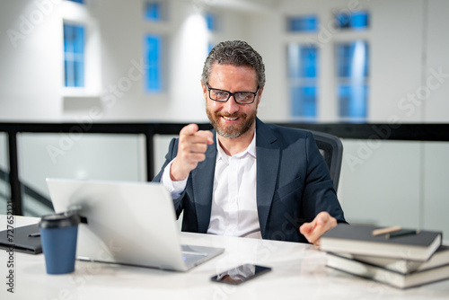 Middle aged businessman working with laptop in office. Hispanic business man using laptop. Millennial man using laptop at office workplace. Ceo manager office worker business people working at office.