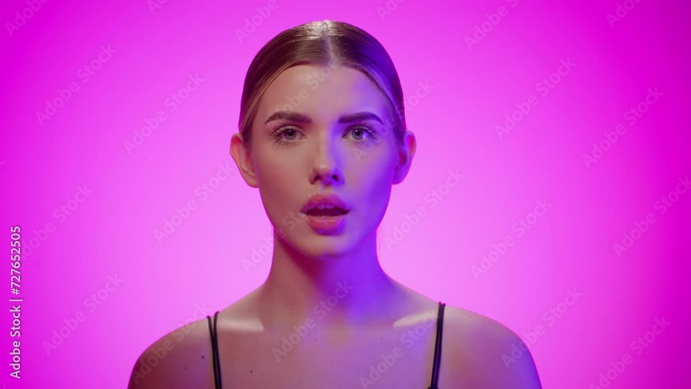 Caucasian young blonde woman opens her mouth raising hands surprised, studio shot, portrait Caucasian young blonde woman opens her mouth raising hands surprised, studio shot, portrait