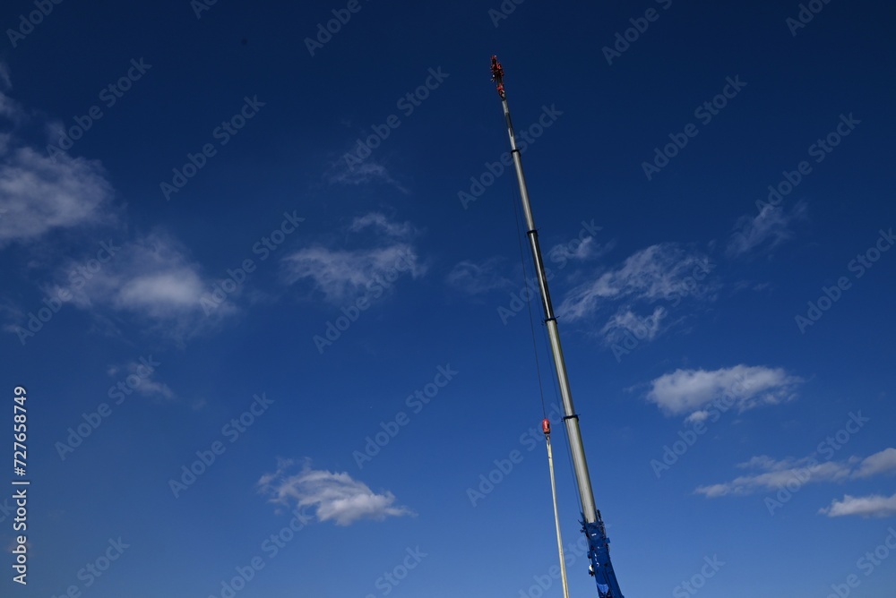 A view of the crane work site. Cranes play an important role at construction sites as heavy-lifting machines. A view of the crane work site. Cranes play an important role at construction sites as heavy-lifting machines.