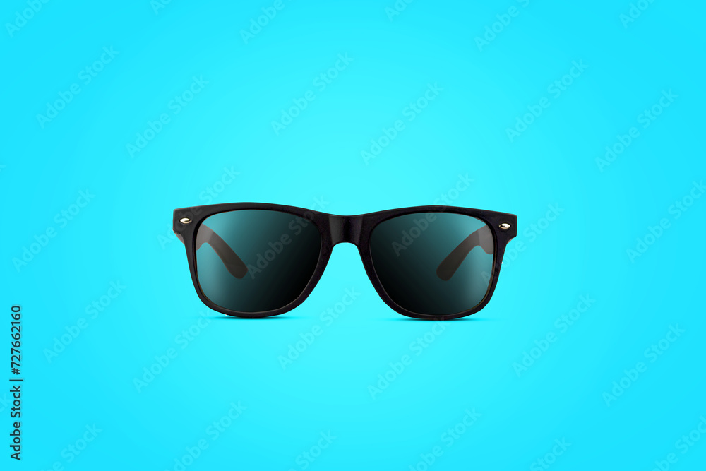 Black sunglasses. On a blue background. Beauty and fashion. Background.