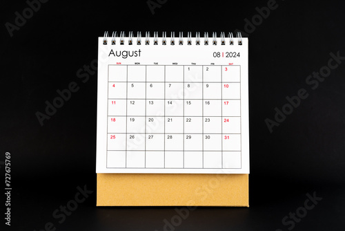Desk Calendar for August 2024. Desktop calendar on a black background. © gamjai