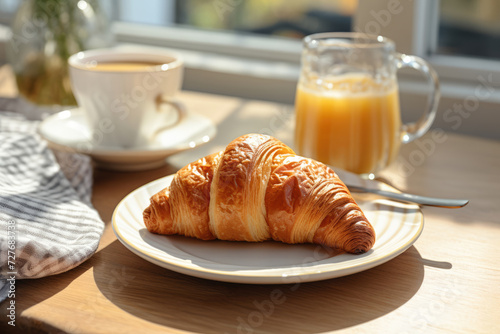 Delicious croissant in a plate, breakfast on the table