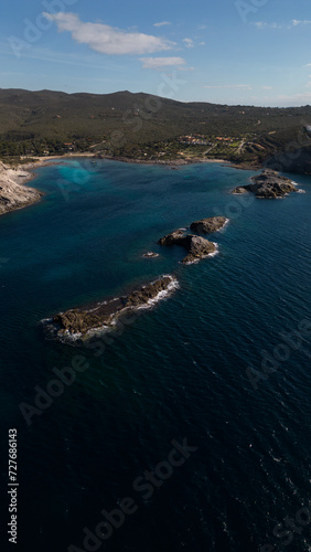 Aerial view of Cala Sapone, S. Antioco bay in Sardinia. Crystal clear sea, moored boat and white sand.