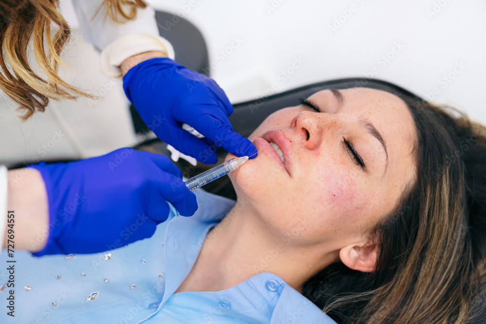 Aesthetician precisely injects hyaluronic acid into the upper lip, providing volume and contour for a refined appearance. Aesthetician precisely injects hyaluronic acid into the upper lip, providing volume and contour for a refined appearance.