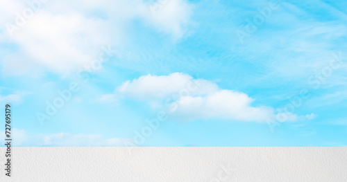 Fototapeta Naklejka Na Ścianę i Meble -  Summer Sky Blue,Cloud over White Concrete Exterior Wall Texture Background,Horizon Backdrop panoramic banner Beautiful nature landscape Spring Clear Sky with Podium mockup display for product present