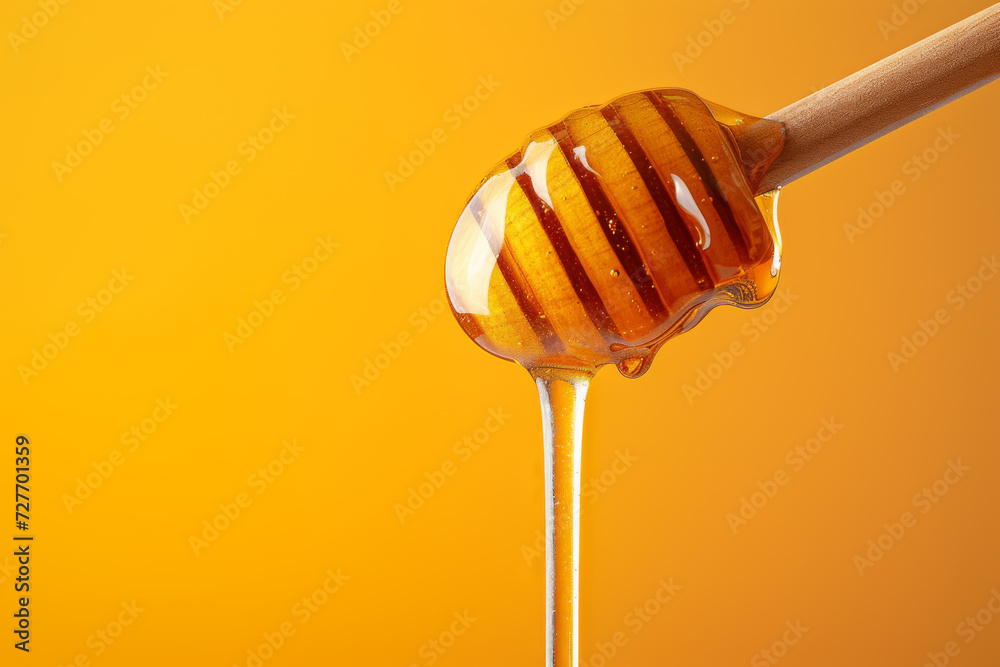 Wooden Honey Dipper Drizzling Honey on Orange Background Wooden Honey Dipper Drizzling Honey on Orange Background