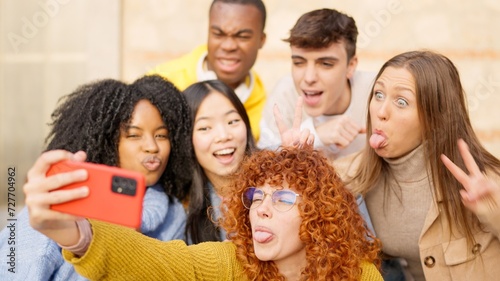 Multiethnic friends having fun on the street taking a selfie