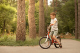 Little boy riding a bicycle in the park. Healthy lifestyle concept
