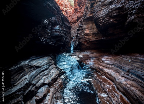 Spider Walk in Karijini Park in Western Australia, erosion and waterfall with pool photo