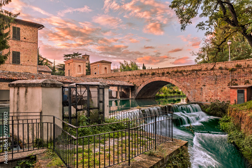 view of Bevagna, Umbria, Italy, with bridge, canal of the old mills and waterfalls