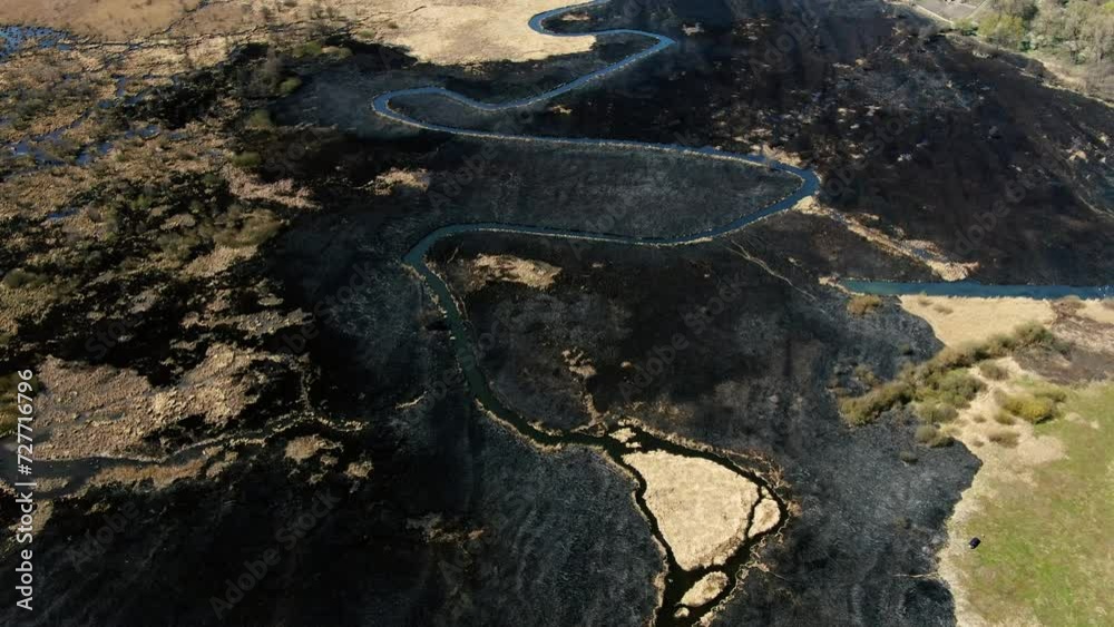 Aerial View of Serpentine Waterway Cutting Through Burnt Landscape Aerial View of Serpentine Waterway Cutting Through Burnt Landscape