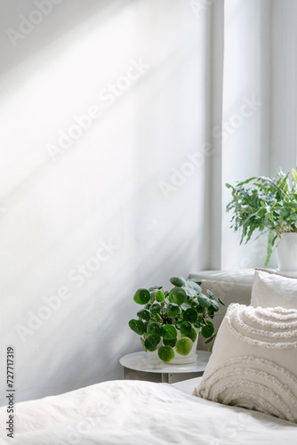 Minimalistic interior design in bedroom with comfortable bed with fresh cotton bedding