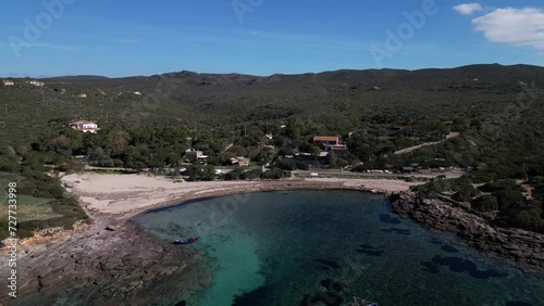 Aerial view of Cala Sapone, S. Antioco bay in Sardinia. Crystal clear sea, moored boat and white sand.
