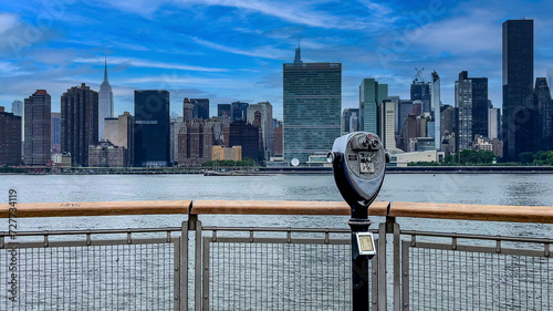 Strolling along the pier viewer and observer with binoculars of Long Island is an island that extends from the east of New York City (USA).