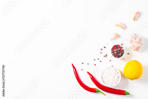 White cooking background with spices, vegetables and utensils. Top view. Free space for your text.