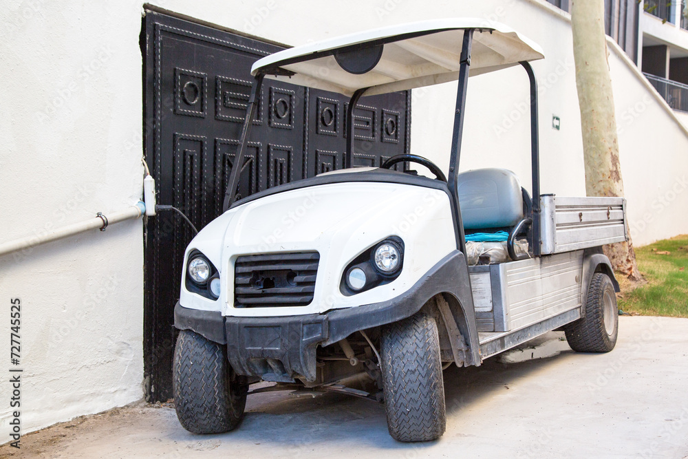 Old electric vehicle with a body for work on the hotel premises.