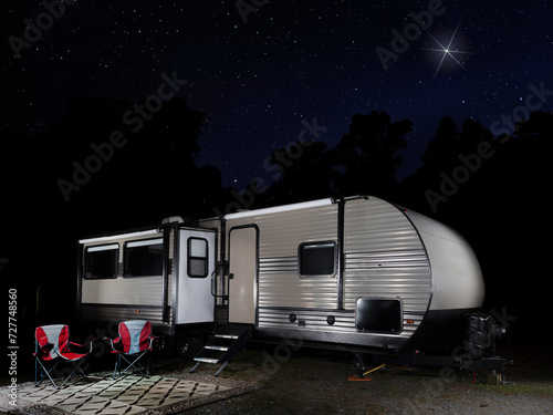 RV at a campsite on a star filled night with one standout