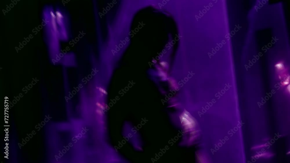alluring stripper woman dancing in darkness, silhouette of beautiful slender lady in laser rays alluring stripper woman dancing in darkness, silhouette of beautiful slender lady in laser rays