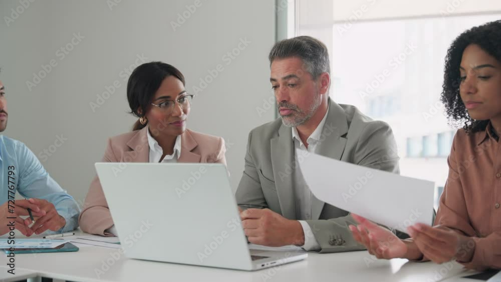 International diverse professional executives business team workers and board leaders group using laptop computer discussing corporate management working in office collaborating at group meeting.