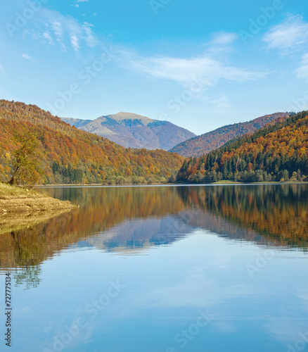 Vilshany water reservoir on the Tereblya river, Transcarpathia, Ukraine. Picturesque lake with clouds reflection. Beautiful autumn day in Carpathian Mountains. © wildman