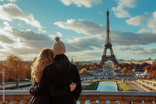 Back view of young couple standing in front of Eiffel Tower in Paris