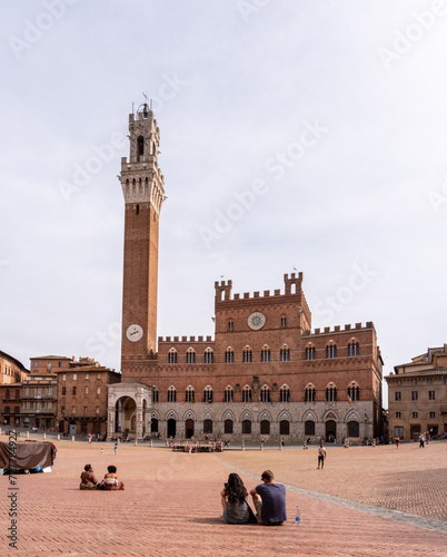 SIENA, ITALY - SEPTEMBER 23, 2023 - The iconic Palazzo Pubblico at the Piazza del Campo in downtown Siena