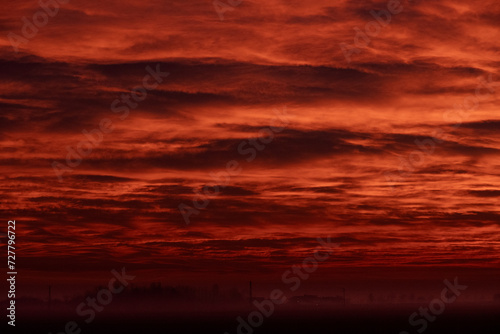 Risveglio infuocato, alba invernale rosso fuoco nella campagna veneta photo