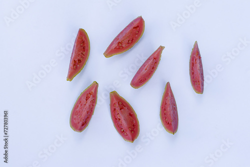 slices/pieces of red guava fruit on a white background, red guava is an alternative traditional medicine