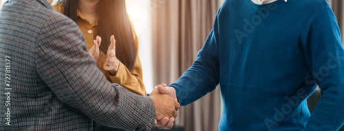 Close up two men shake hands at business meeting, office negotiations. Making deal sign, conclude contract, reach agreement, formal greeting, strike bargain. Successful negotiations.
