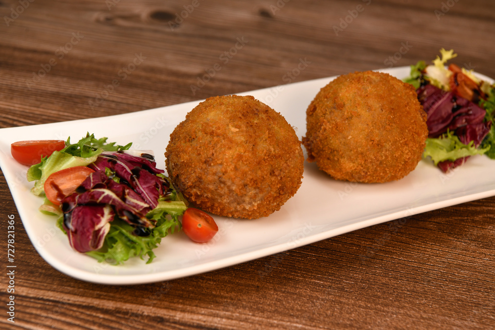 RECIPE FOR BREADED BEEF MEATBALLS STUFFED WITH A SOFT BOILED EGG. High quality photo RECIPE FOR BREADED BEEF MEATBALLS STUFFED WITH A SOFT BOILED EGG. High quality photo