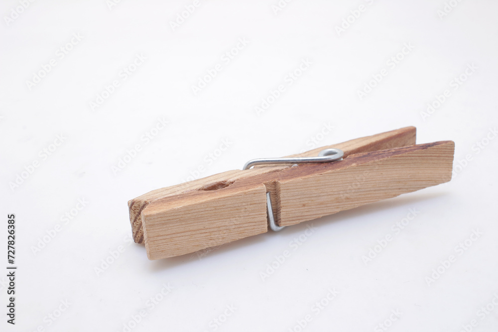 a Wooden clothes peg isolated on white background a Wooden clothes peg isolated on white background