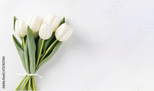 Bouquet of white tulips on a white background. Flat lay, top view.