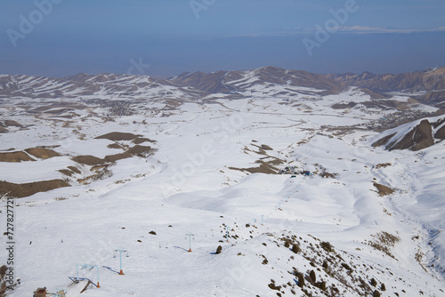 Natural landscape, mountain slope. Active leisure, winter sports. Toguz Bulak ski resort in Kyrgyzstan. Cableway for skiers and snowboarders.  photo