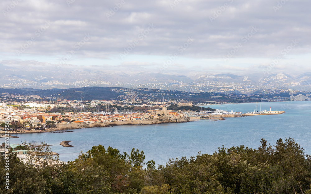 View of Juan les Pins with the old city centre of Antibes and Port Vauban harbor in the background. Cote d'Azur, French Riviera, France
