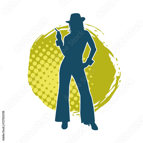 Silhouette of a slim female model wearing long pants and fedora hat in pose.
