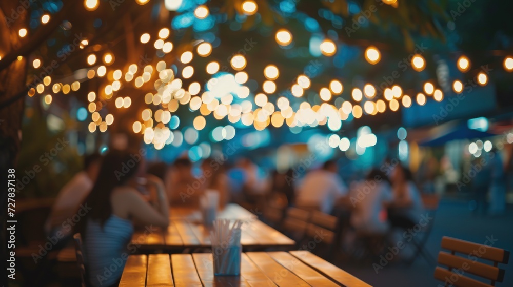 People hanging out having and listening to music together at roadside Restaurant on bokeh background - obrazy, fototapety, plakaty 