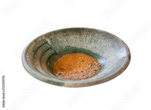 Location photos The face is clear, the back is blurry. Focus on a gray stone dishware on a long blue iron bar. In the container put some brown liquid into pellets like animal feed. Below is the brown