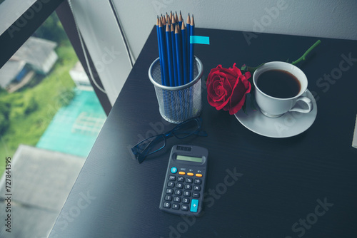 Top view office desk smart tablet document paper, coffee cup roses on wood table with copy space. Tabletop notebook office empty blank white paper pen coffee cup to display workspace wood background