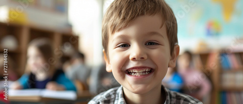 A beaming young boy with a toothy grin sits in a vibrant classroom, embodying the joy of early education