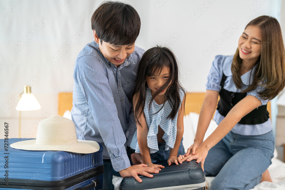 Portrait happy love asian family father and mother with little girl traveler packing stuff and outfit clothes in suitcases travel bag luggage for summer holiday weekend tourist vacation trip at home Portrait happy love asian family father and mother with little girl traveler packing stuff and outfit clothes in suitcases travel bag luggage for summer holiday weekend tourist vacation trip at home