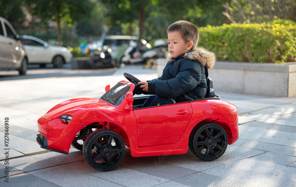 Adventurous Toddler Drives Red Sports Car with Joyful Glee Adventurous Toddler Drives Red Sports Car with Joyful Glee