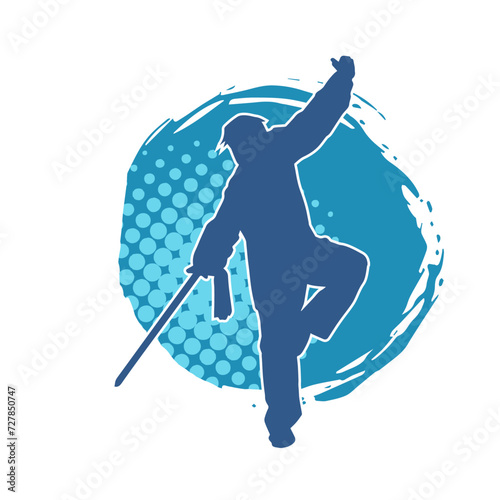 Silhouette of a kungfu or wushu martial art athlete in action pose. Silhouette of a male martial art person in pose with swords weapon.
