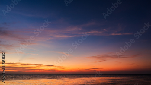 Sunset sky clouds over sea in the evening on twilight with colorful sunlight after sundown, Dusk sky background © Nature Peaceful 