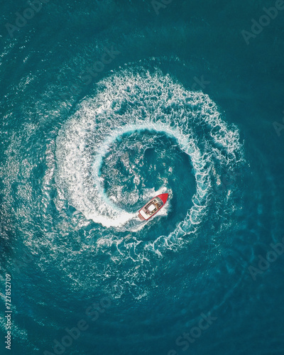 Aerial photography of a boat creating circle with a wake in the sea close to Crete island in Greece - Drone Photo © Marc