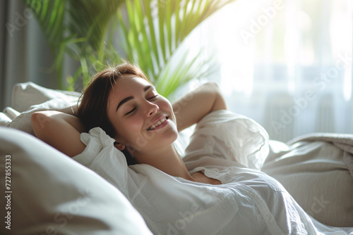 Relaxing at home, a happy woman lying on the sofa enjoying the moment, self-care concept