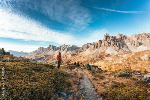Male hiker standing with enjoying the massif Des Cerces in Claree Valley at French Alps